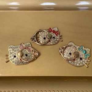 Hello Kitty Jeweled Bow Phone Rings - Pink Red or Blue NWT Rotating Metal Stand